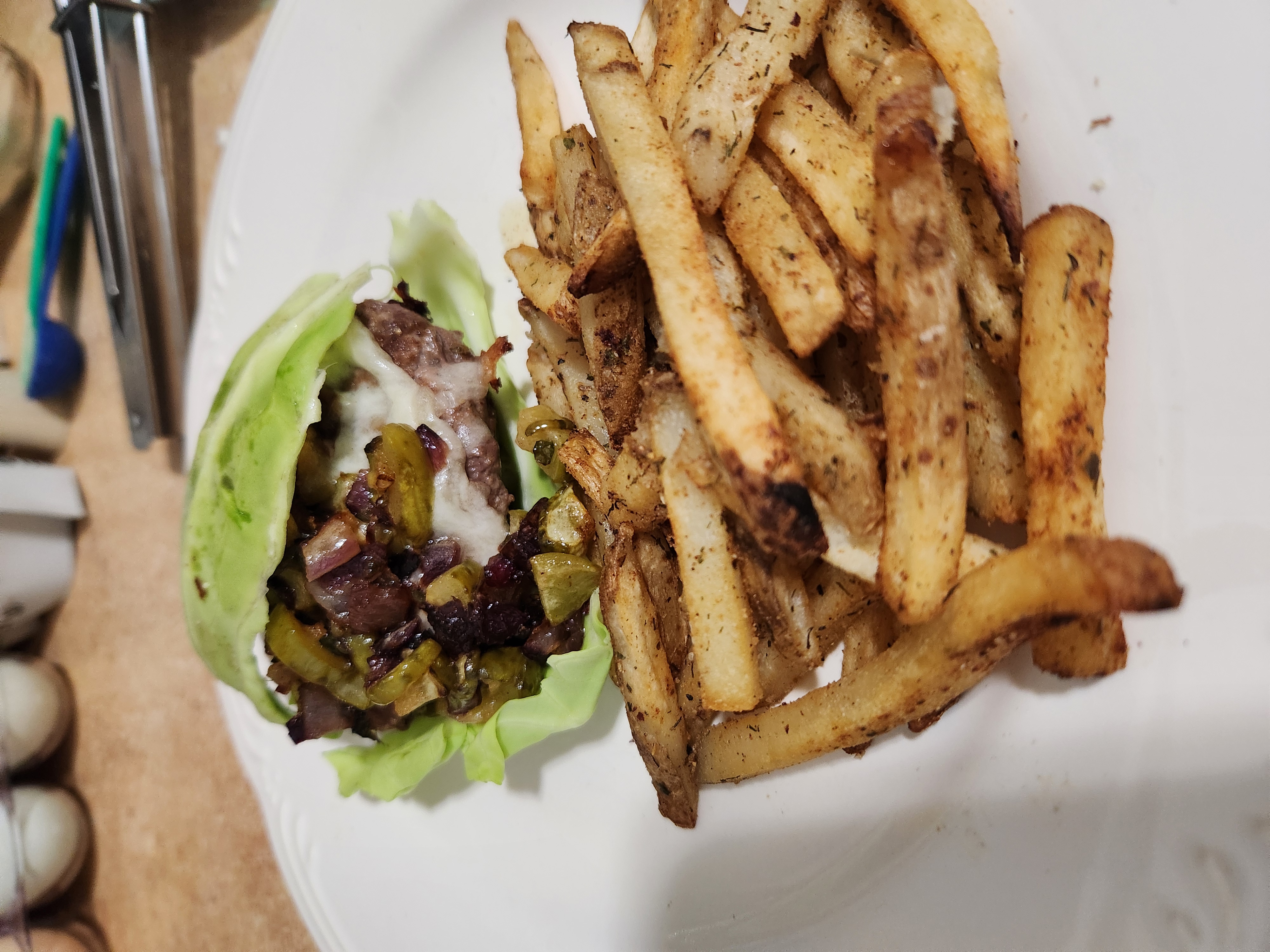 Lettuce wrapped ranch burger with avocado, peppers, onions and fries